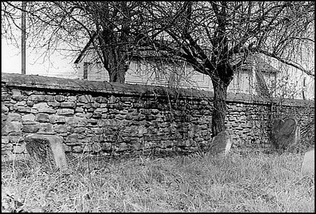 Na idovském hbitov, za zdí je sklad bývalého cukrovaru.